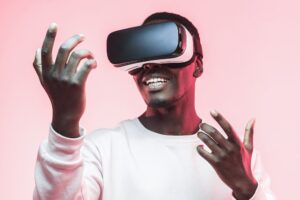 Amazed excited young african american man, wearing high tech smart vr goggles