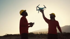 Drone engineers working on construction site - Aerial engineering concept