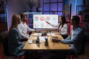 Four workers discussing economic development of company