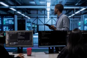 IT worker in server room monitoring server infrastructure