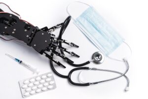 Real robotic hand with medical equipment and drugs.