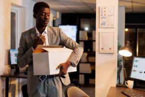 Sad businessman leaving company startup office