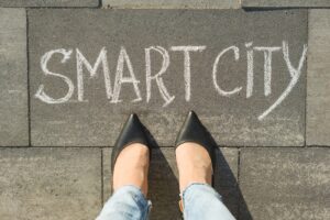 View from above, female feet with text smart city written on grey sidewalk.
